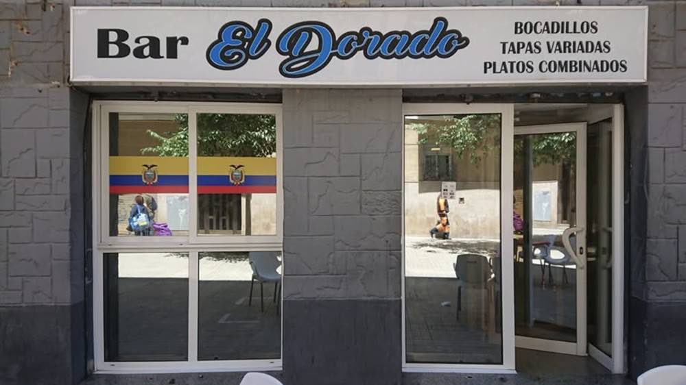 The front of Bar El Dorado, with its sign and the Ecuadorian flag in the window.